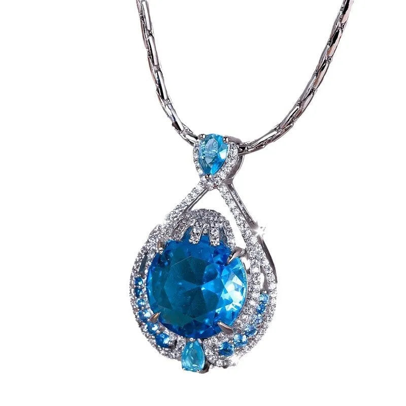 Geometric women's necklace with blue fireworks-cut crystal gems on a water wave chain.