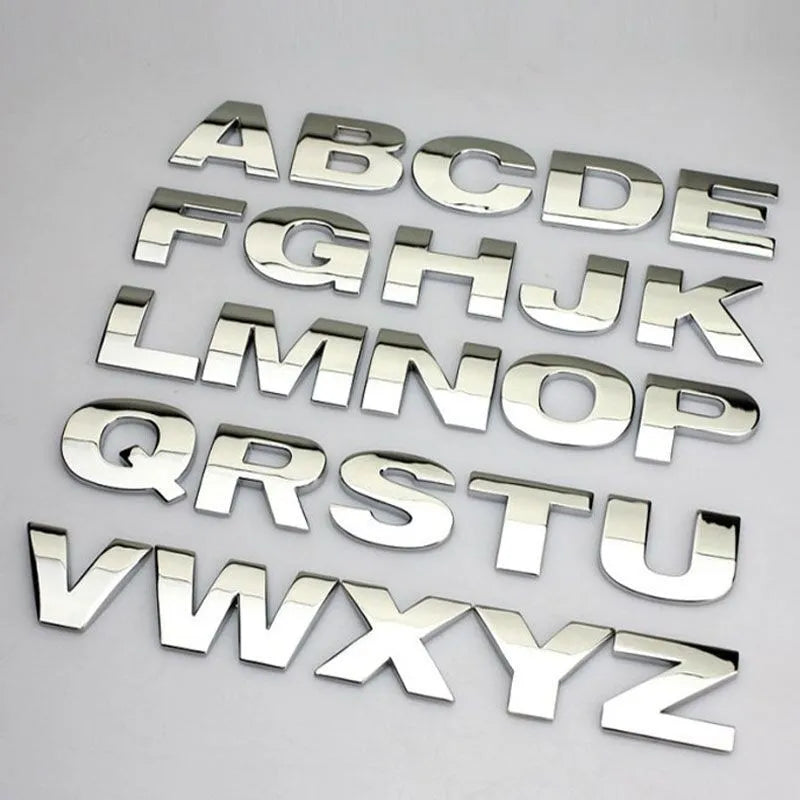 3D metal zinc alloy car letter sticker in black or silver, shown actual size at 2.5cm.
