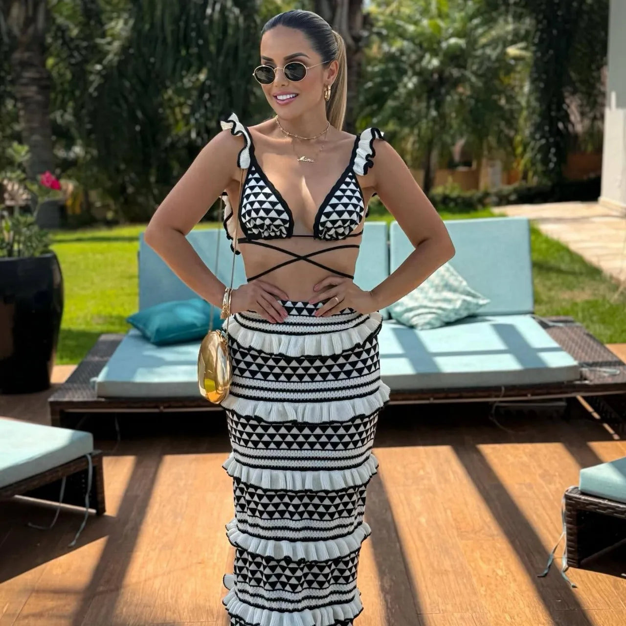 Black and white striped ruffled bikini top with spaghetti straps paired with a long knitted skirt.