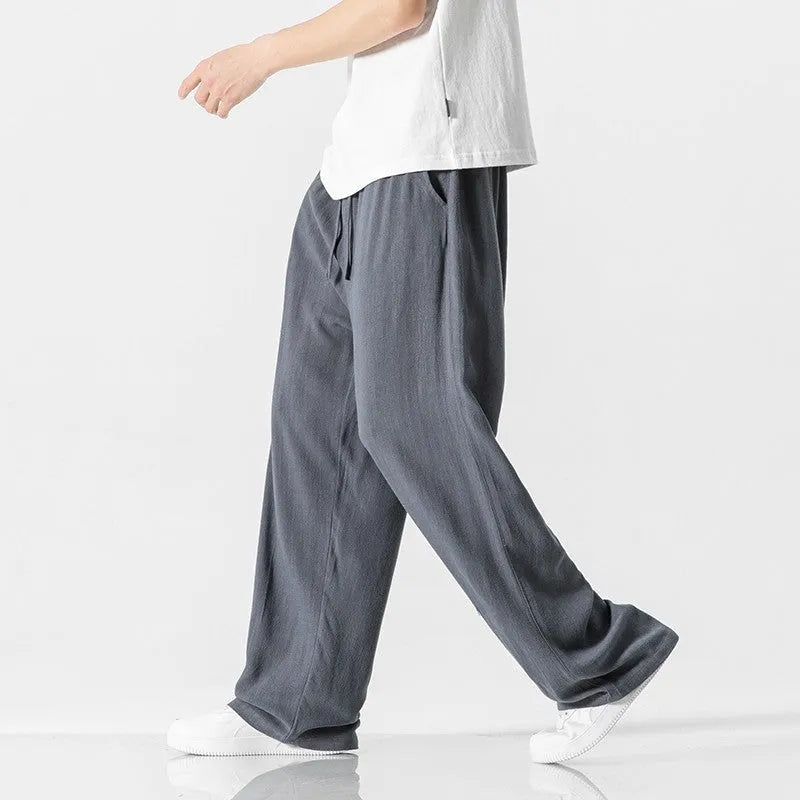 Men's beige bamboo fibre linen trousers with a straight leg, cropped length, and drawstring waist.