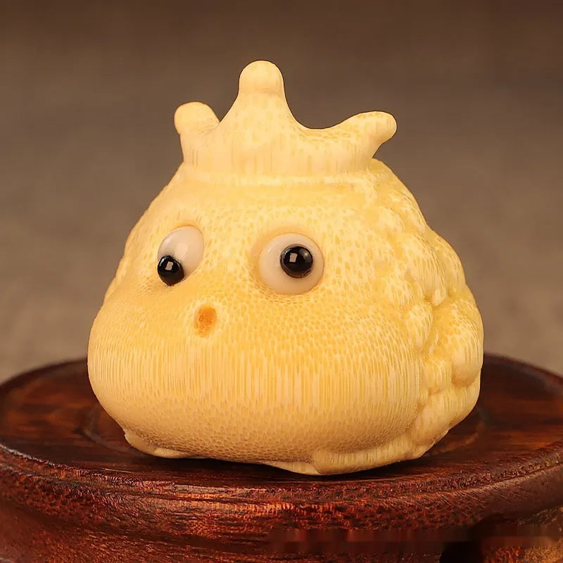Solid bamboo carving of a Crown Princess toad ornament with live eye detail in a cute style.