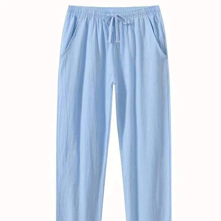Men's loose-fitting cotton beach pants in khaki colour on a casual background.