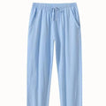 Men's loose-fitting cotton beach pants in khaki colour on a casual background.