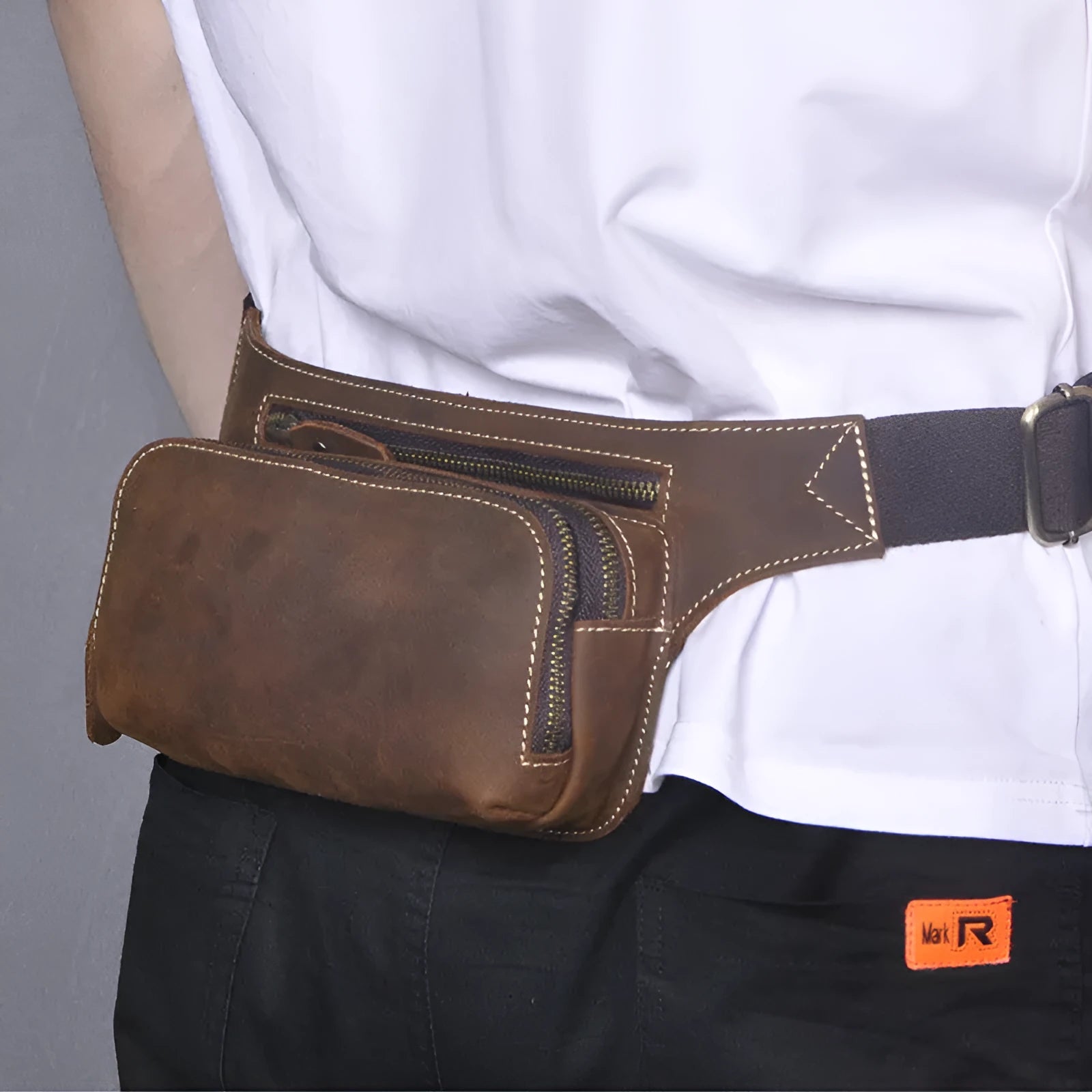 Brown cowhide leather men's sports waist bag with zip and internal phone pocket.