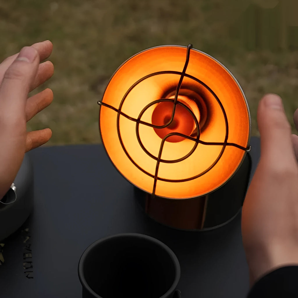 Black and orange portable gas heating stove for camping with automatic ignition.