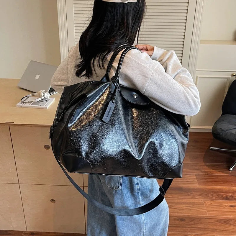 Black hand-carry travel bag for women with large 36-55 litre capacity