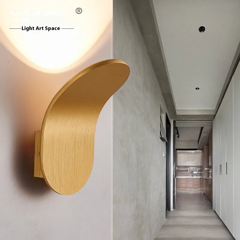 Modern brushed metal wall lamp in gold finish with contemporary design for accent lighting