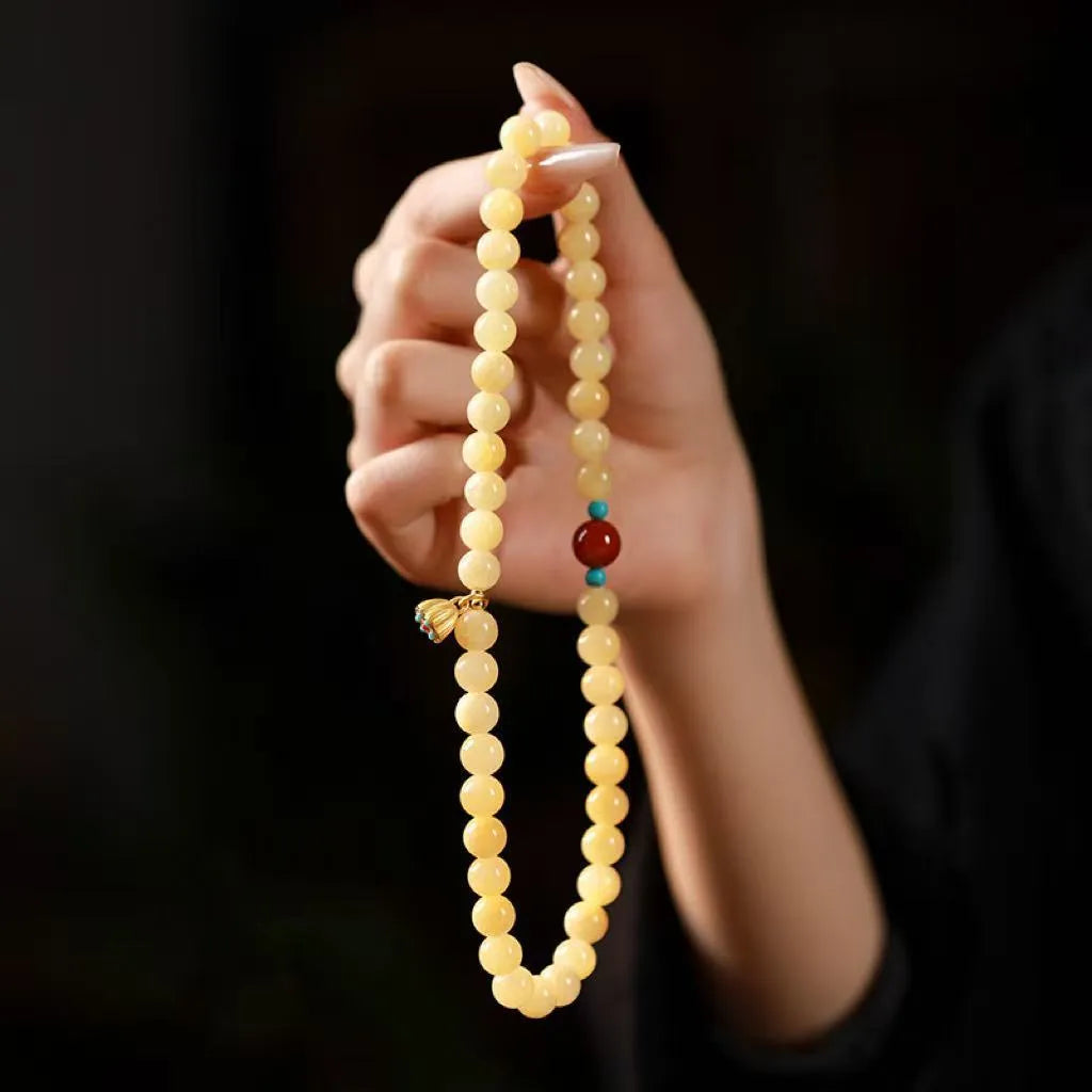 Yellow jade double ring bracelet with lotus seedpod design in hand-woven construction