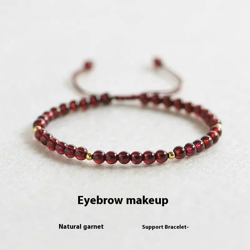 Hand-woven red rope garnet bracelet on a wrist, showing flexible wire and new Chinese style.