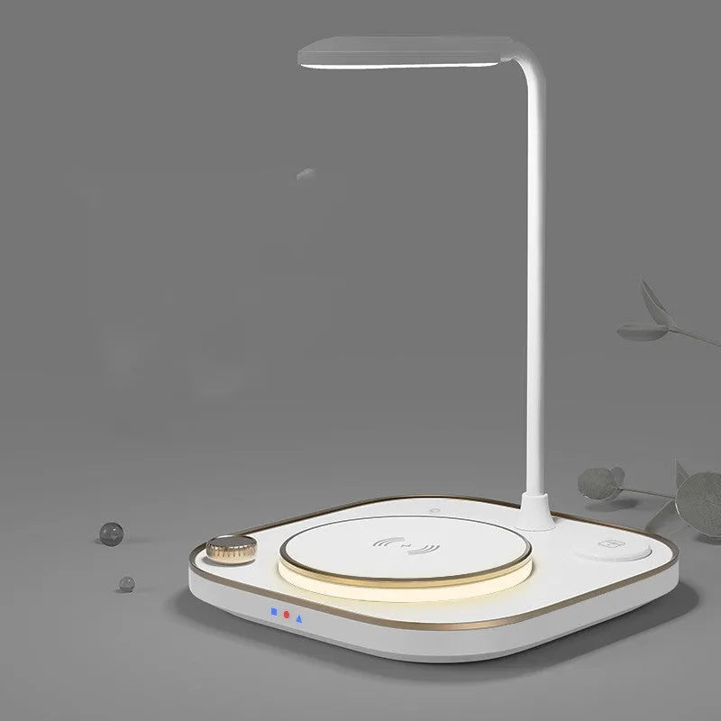 Black three-in-one wireless magnetic charger with desk lamp and USB cable on a wooden desk.