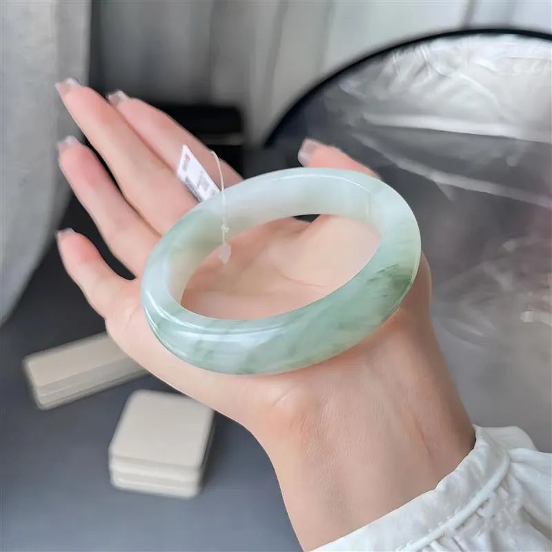 Tian Shan Cui bracelet with floating flowers design and animal zodiac modelling in ice-like jade
