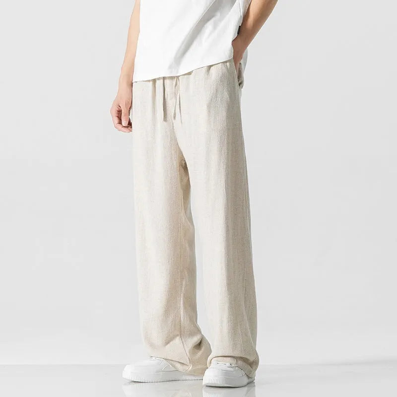 Men's beige bamboo fibre linen trousers with a straight leg, cropped length, and drawstring waist.