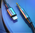 Black Apple Lightning to 3.5mm audio cable with shiny braided finish and aluminum connectors for car use.