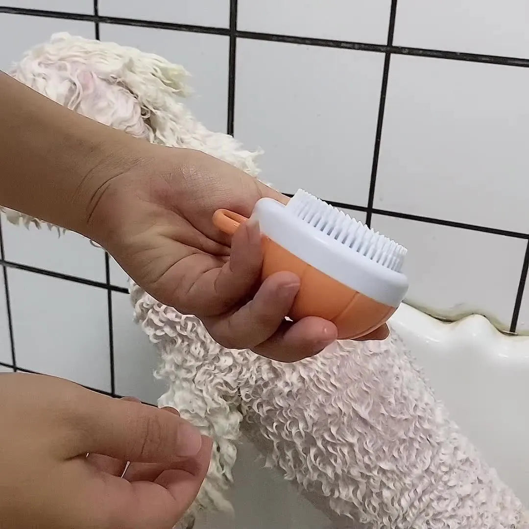 Orange TPR pet bath brush with shampoo dispenser and silicone bristles for dog and cat grooming