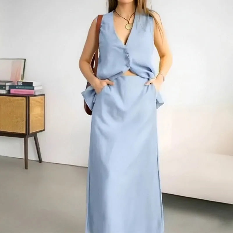 Women's white polyester two-piece set with sleeveless vest and long skirt on a hanger