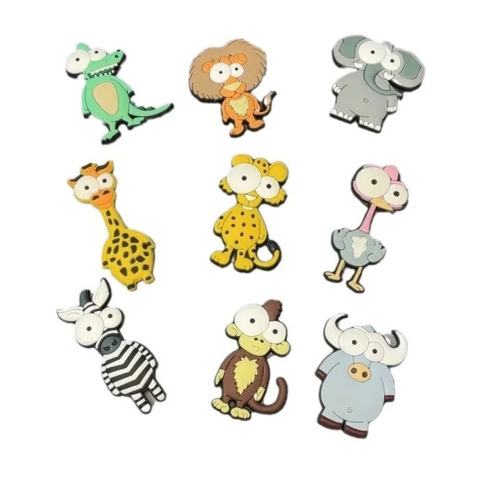 Set of 9 PVC cartoon animal refrigerator stickers with safari animals including monkey, lion, and giraffe on a white fridge door.