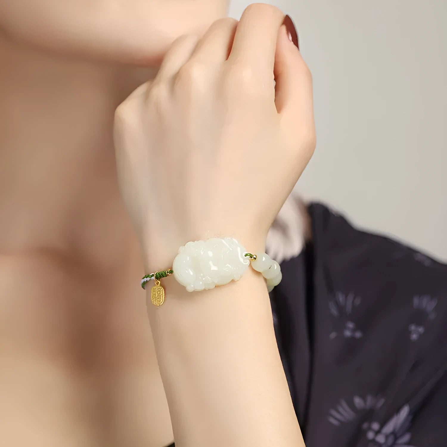 Hetian Jade Chinese zodiac bracelet on red cotton rope with S925 silver card for Year of Rabbit.