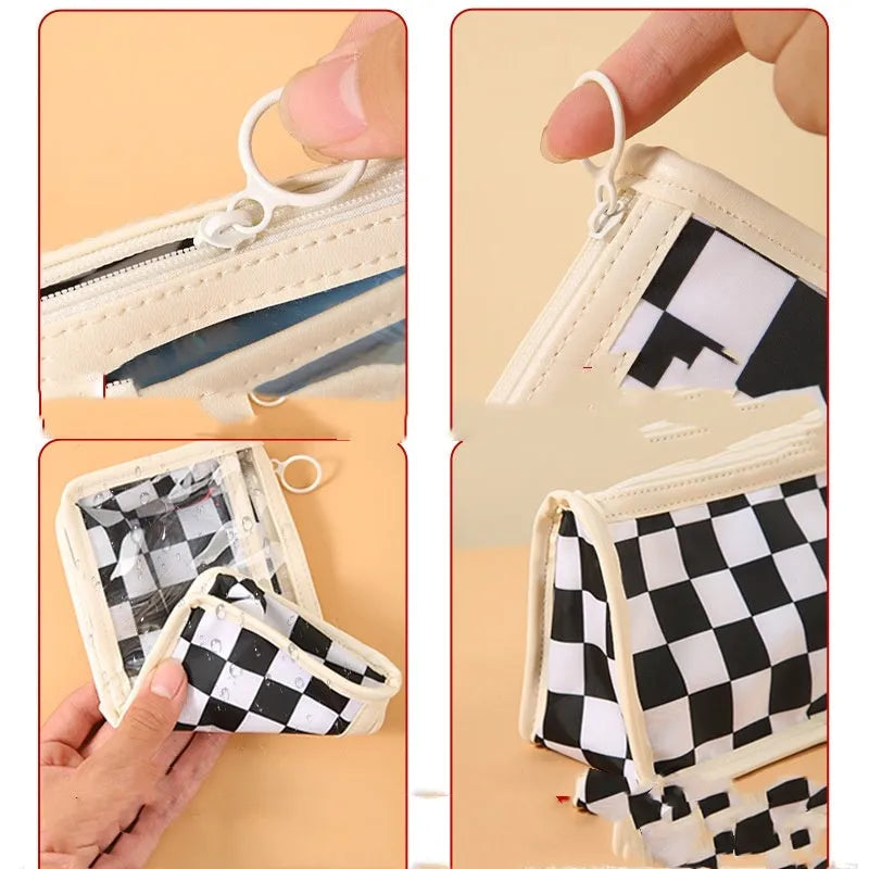 Transparent PVC pencil case with chessboard pattern, open to show large interior for pens.