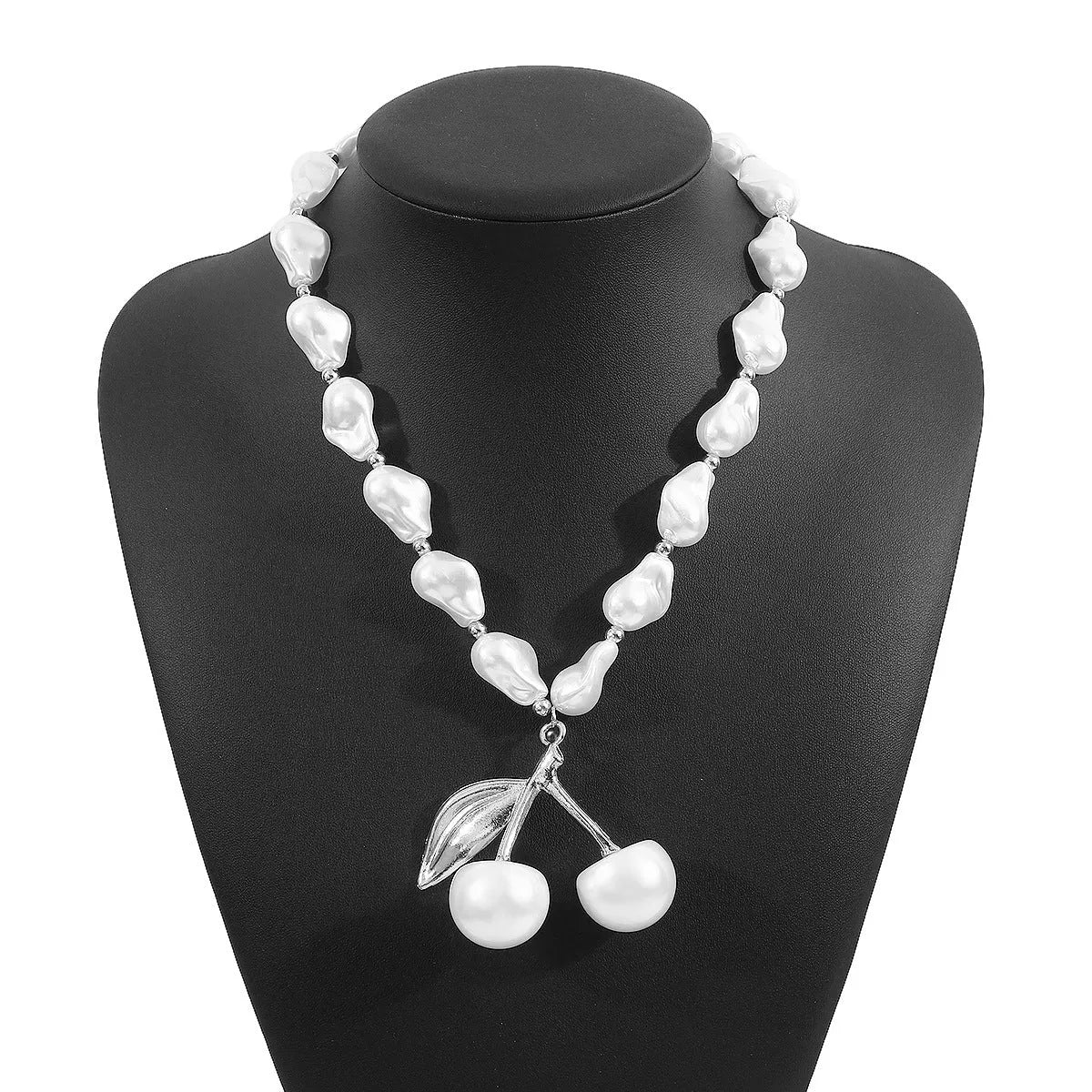 Gold electroplated cherry fruit pendant on an adjustable white pearl chain necklace for women.