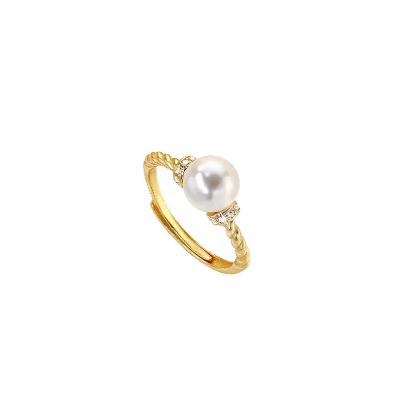 Adjustable copper ring with antique twist design and inlaid pearl in gold finish.