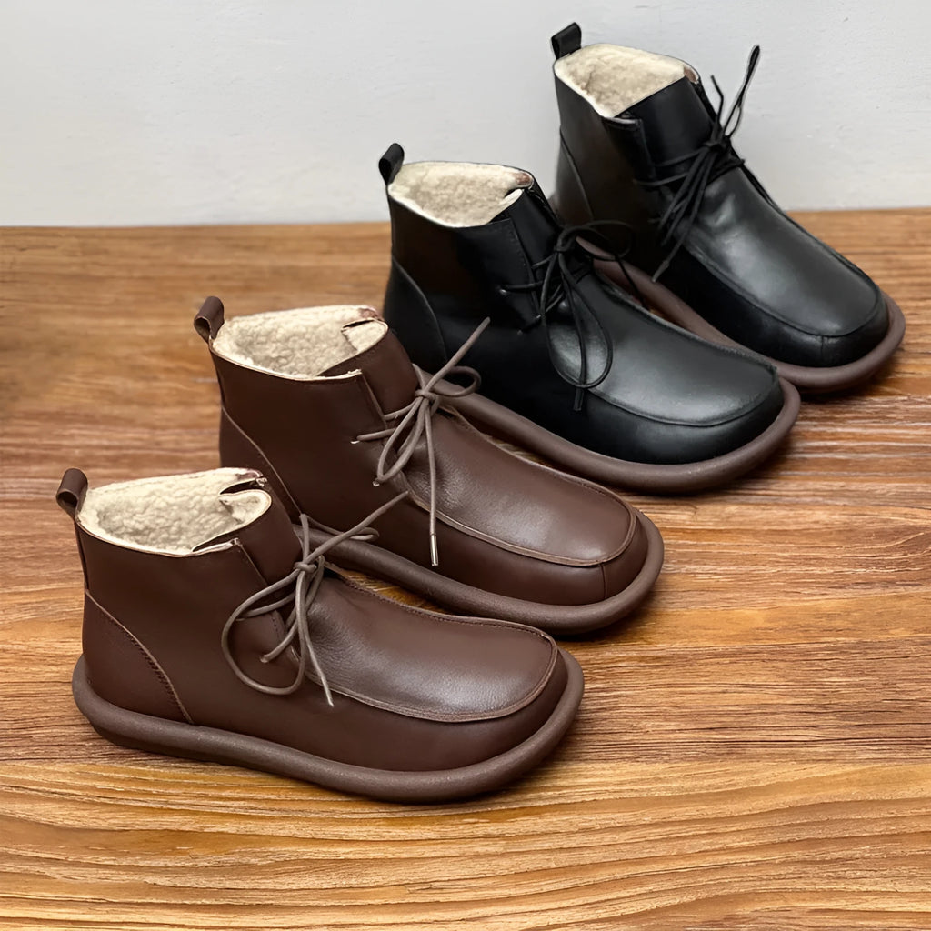 Women's casual cowhide boots with velvet lining in black and coffee colours showing round toe and flat heel design