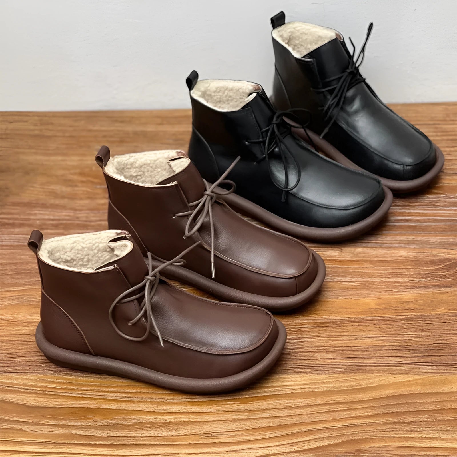 Women's casual cowhide boots with velvet lining in black and coffee colours showing round toe and flat heel design
