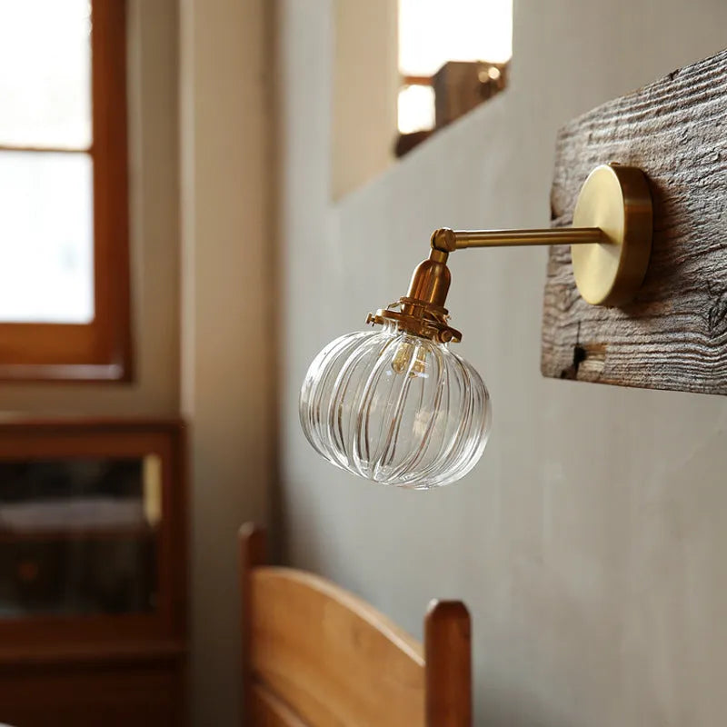 Pumpkin-shaped glass wall lamp in blue and transparent colour options.