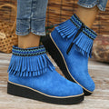 Women's dark brown suede wedge ankle boots with side zip and tassel detail on a thick rubber sole.