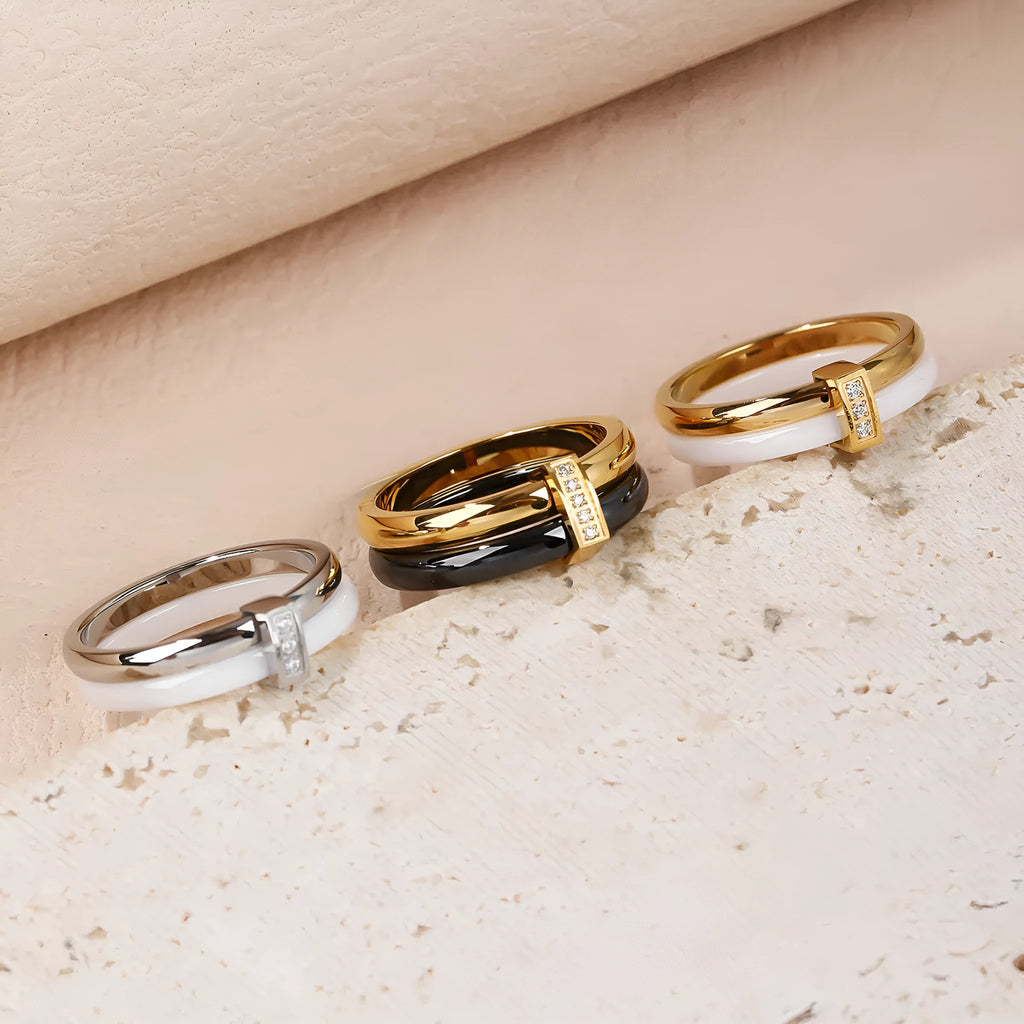Glossy titanium steel women's ring with heart shape formed by a double band and zirconium inlay.