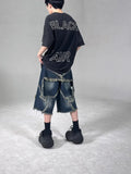 Blue men's denim shorts with a loose fit, frayed hem, and an embroidered five-pointed star on the leg.