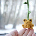 Handmade green plush frog woven pendant for car interior decoration.