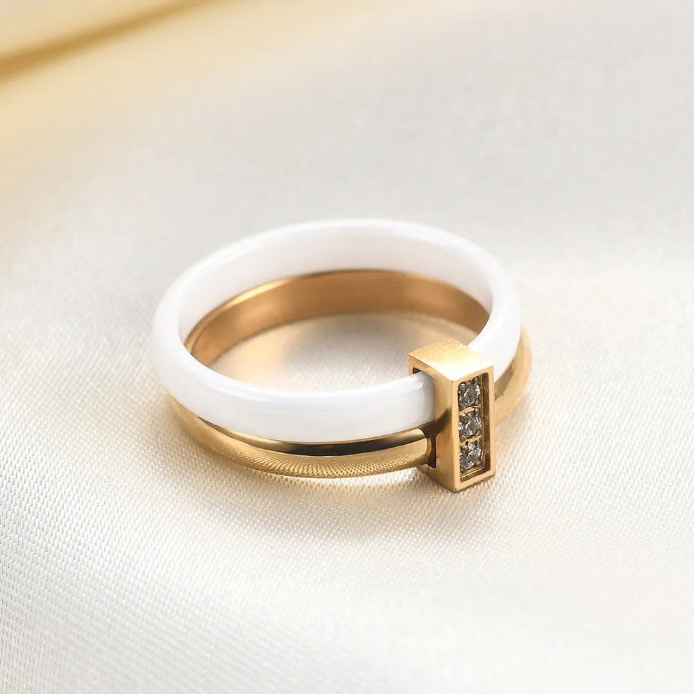 Glossy ceramic women's ring with inlaid zirconium design in geometric shape, shown in gold white finish.