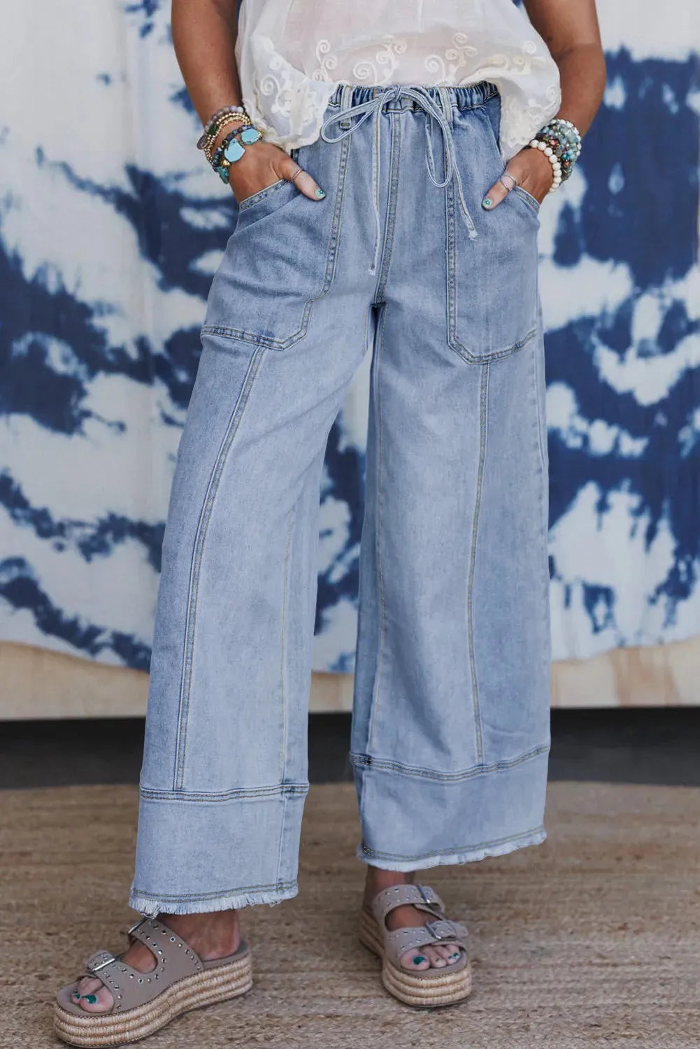 Beau blue wide leg denim trousers with drawstring seam detailing and raw hem finishing