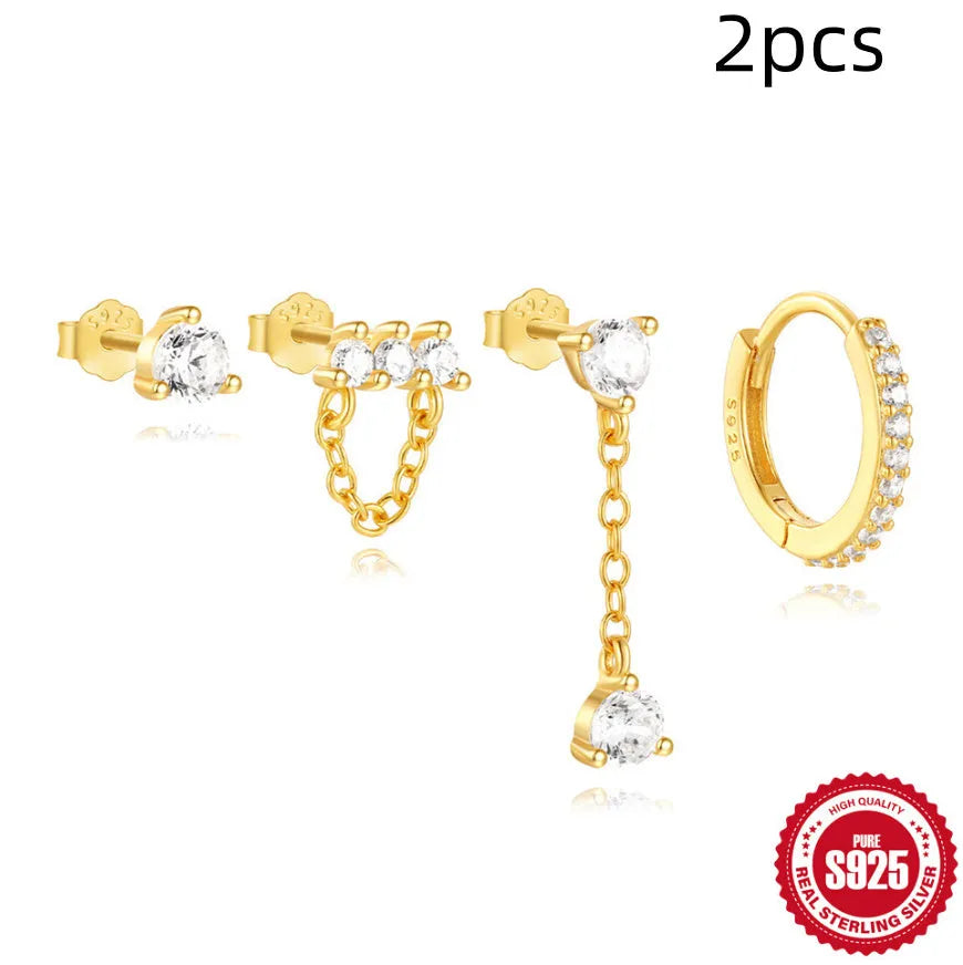 A pair of S925 sterling silver earrings with a geometric clover petal design and an electroplated gold finish.