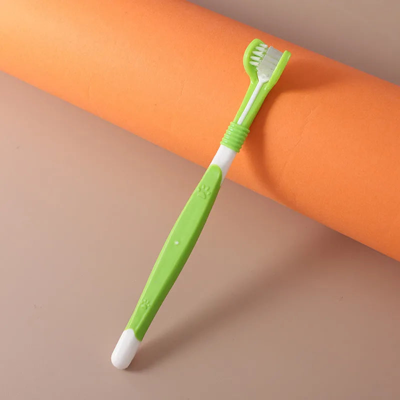 Pet toothbrush with angled head in assorted colours including orange, dark green and blue pink