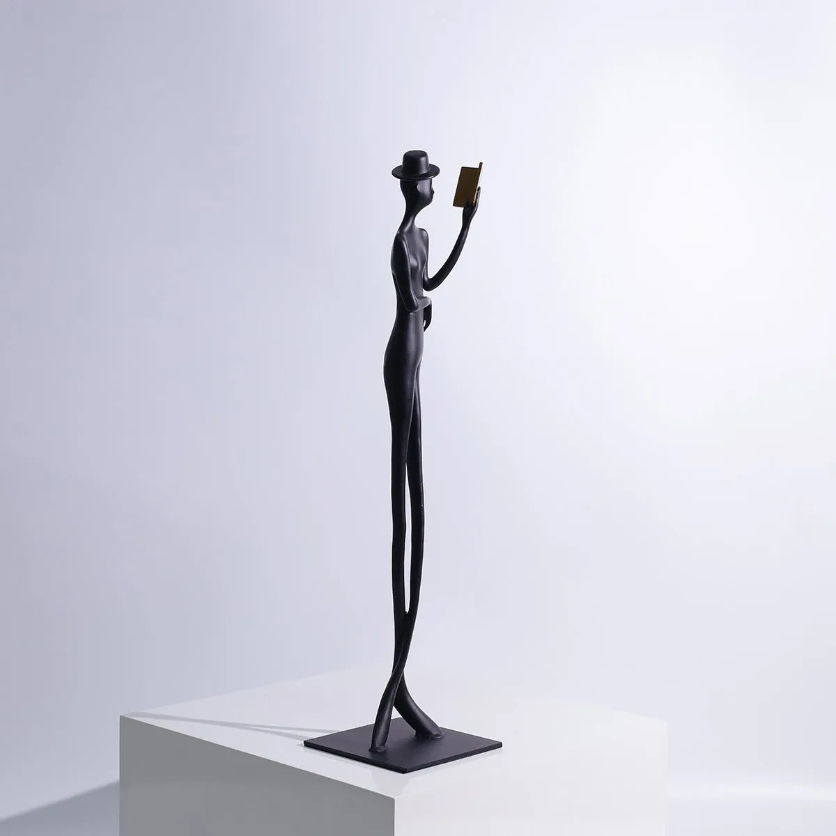 Black cast aluminium reading woman sculpture, 51cm tall modern desktop ornament.