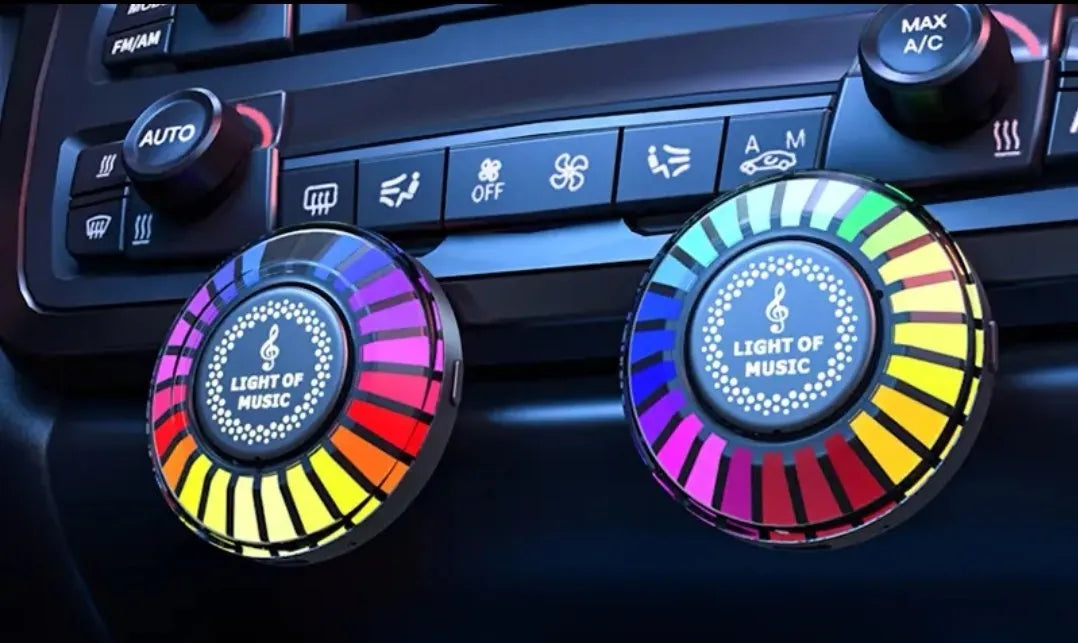 Car air vent mounted RGB atmosphere light with voice control and aromatherapy pod.