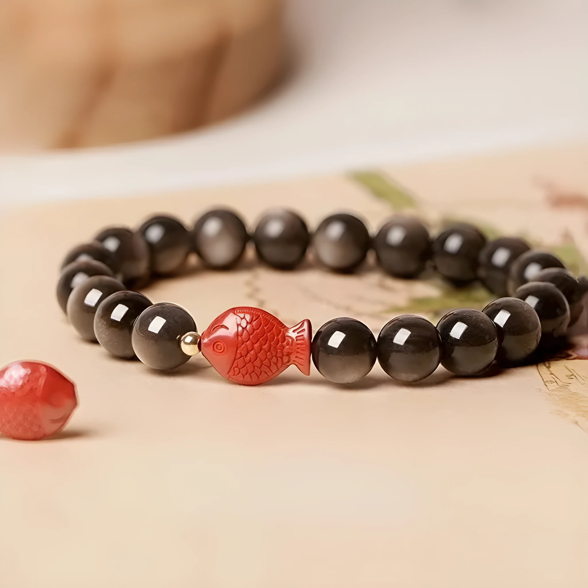Natural obsidian and cinnabar round bead bracelet shown in 6mm, 8mm, and 10mm size options.