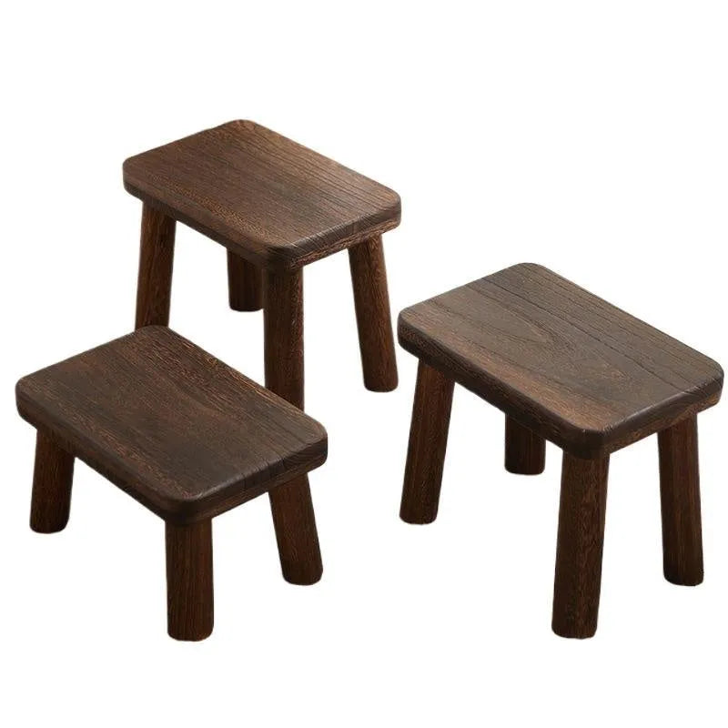 Solid wood household changing stool with distressed finish and bracket structure legs.