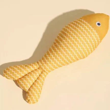 Yellow catnip fish plush chew toy for cats lying on a wooden floor.