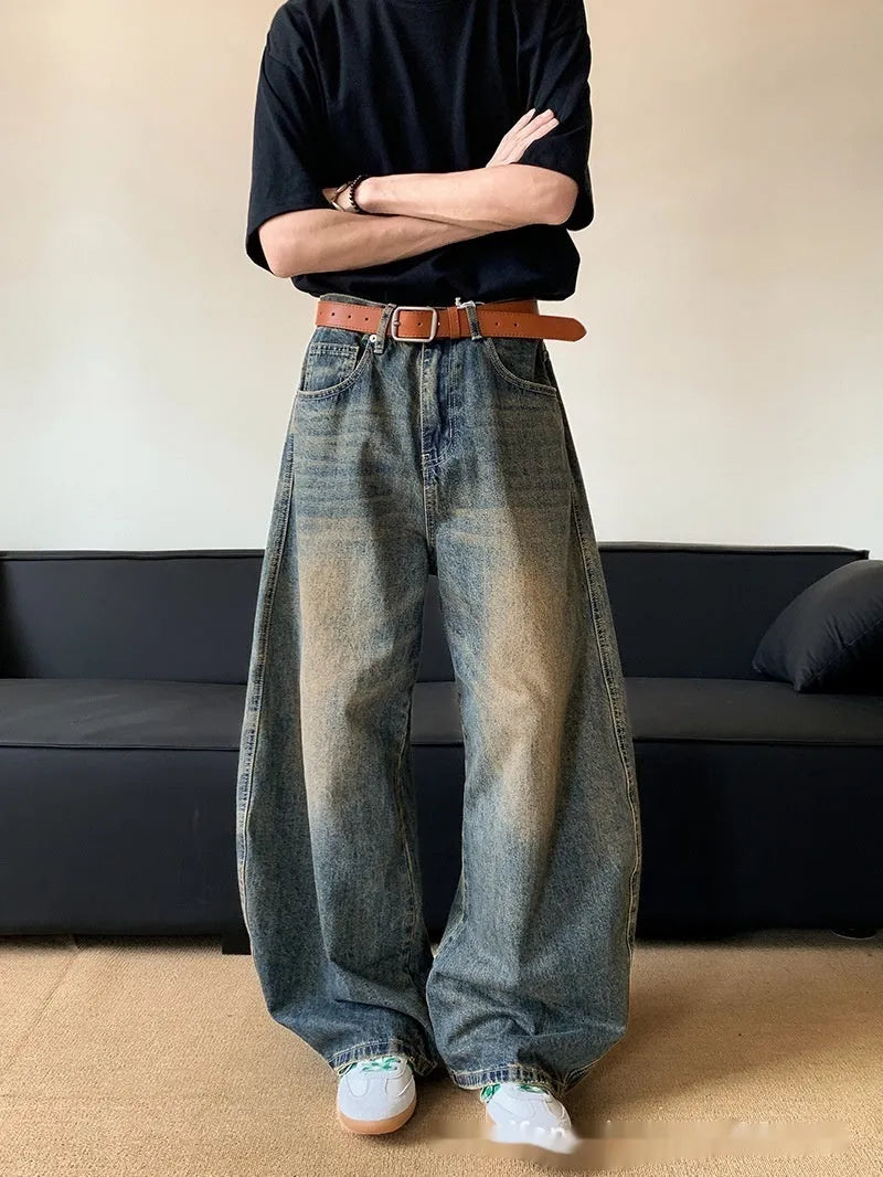 Man wearing retro blue distressed wide-leg denim jeans with machete detailing
