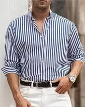 Man wearing a loose-fit khaki striped button-down cardigan-style shirt.