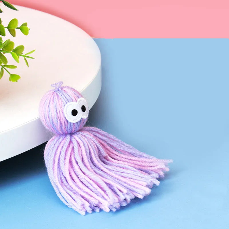 Wool ball cat toy in pink and blue colours with hanging attachment
