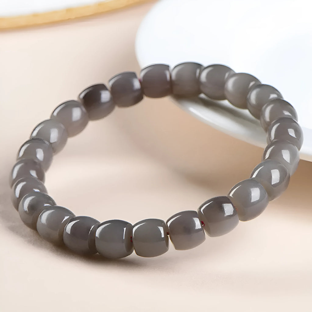 Natural smokey violet Hetian jade straight cut bracelet with 8x9mm beads on a wrist.