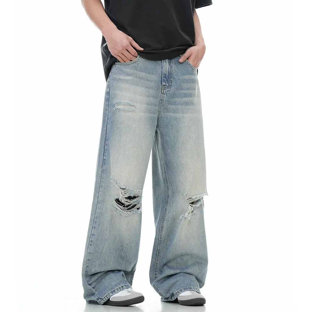 Blue retro-style men's straight-leg jeans with distressed detailing on a solid background