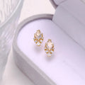 Geometric sterling silver earrings with sweet white crystal studs on white background