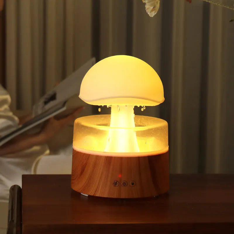 White cloud-shaped humidifier with simulated falling raindrops and coloured LED lighting