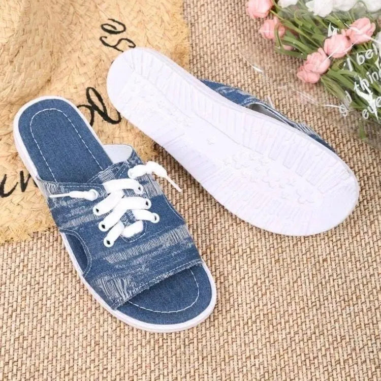 Blue women's flat canvas Roman slippers with a cloth upper and rubber sole.