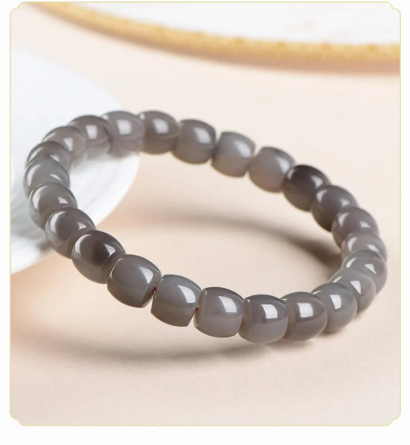 Natural smokey violet Hetian jade straight cut bracelet with 8x9mm beads on a wrist.