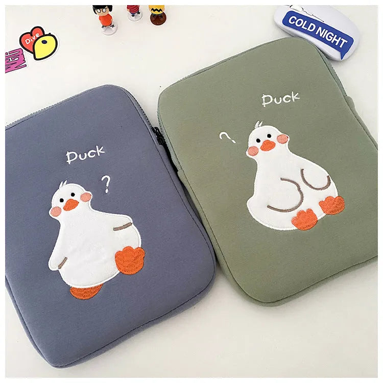 Blue cotton tablet case with embroidered cartoon duck design and a zip closure.